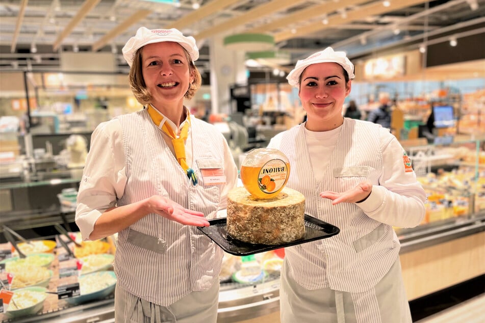 Frau Hofmann (li.) und Frau Renner (re.) stehen Kunden an der Käsetheke für eine Beratung zur Seite.