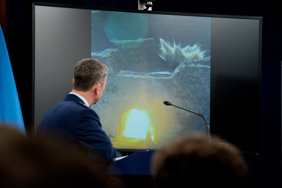 Chairman of the Joint Chiefs of Staff Air Force Gen. Dan Caine watches a video of a bombing test of the GBU-57A/B Massive Ordnance Penetrator used in the attack on the Iranian Fordow Fuel Enrichment Plant during a news conference at the Pentagon on June 26, 2025.