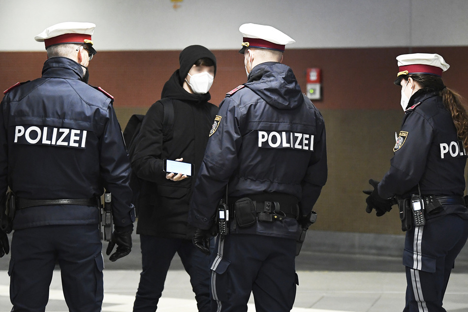 Polizisten kontrollieren eine Person (Symbolbild).