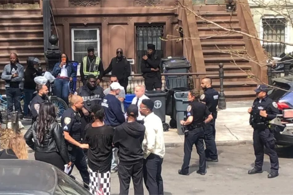 New York City Councilmember Chi Ossé joins demonstrators outside the Brooklyn home of Carmella Charrington.