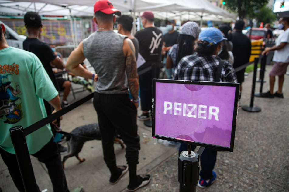 People wait in line to receive the Pfizer vaccine at a mobile vaccine clinic in Brooklyn, New York.