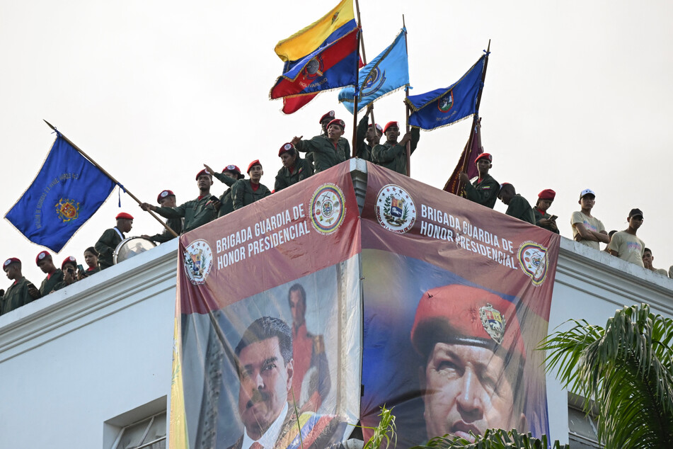 Members of the guard of honor of Venezuelan President Nicolas Maduro stand on the roof at Miraflores presidential palace in Caracas on Tuesday.