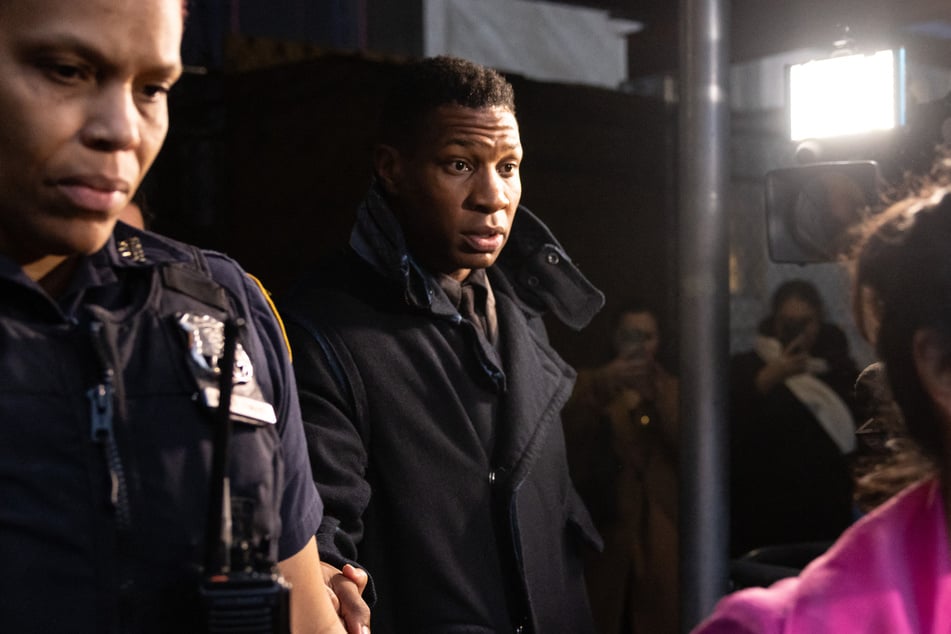 Actor Jonathan Majors (c.) leaves a courtroom after being found guilty of assault and harassment of his former girlfriend, at the Manhattan criminal courts in New York City on December 18, 2023.