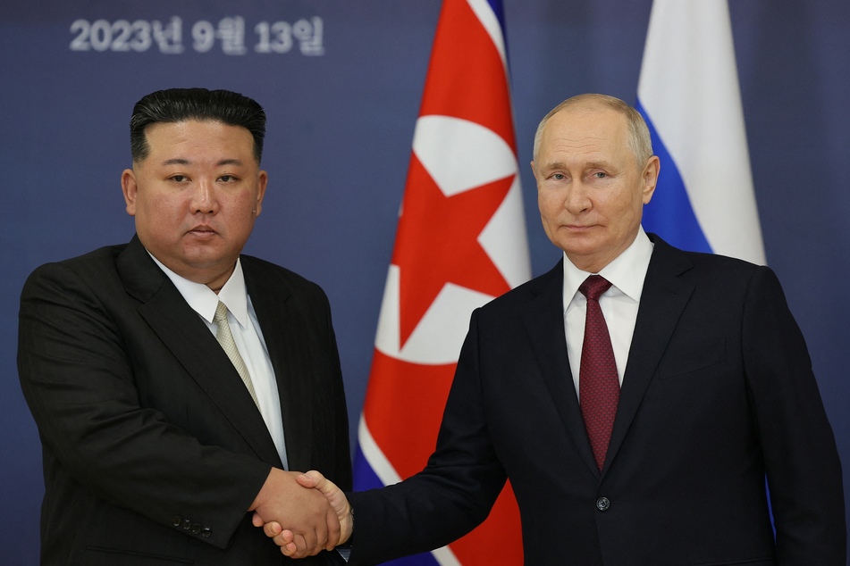 Russian President Vladimir Putin (r.) and North Korea's leader Kim Jong Un shake hands during their meeting on September 13, 2023.