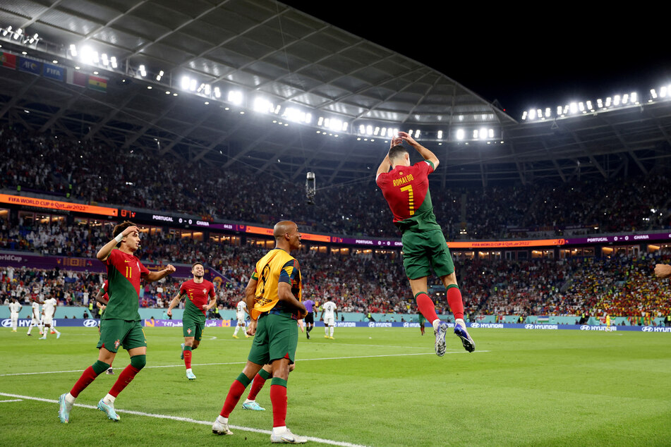 Cristiano Ronaldo (r.) does his trademark celebration after opening the scoring for Portugal against Ghana.