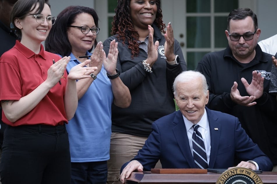 President Joe Biden is applauded by union members in May 2024 after signing orders to raise tariffs on Chinese imports that he says are unfairly subsidized by Beijing, including electric vehicles, solar cells, semiconductors, and advanced batteries.