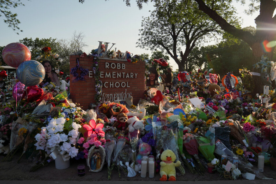 Robb Elementary School is now a memorial site strewn with flowers and crosses in tribute to the victims of its deadly school shooting.