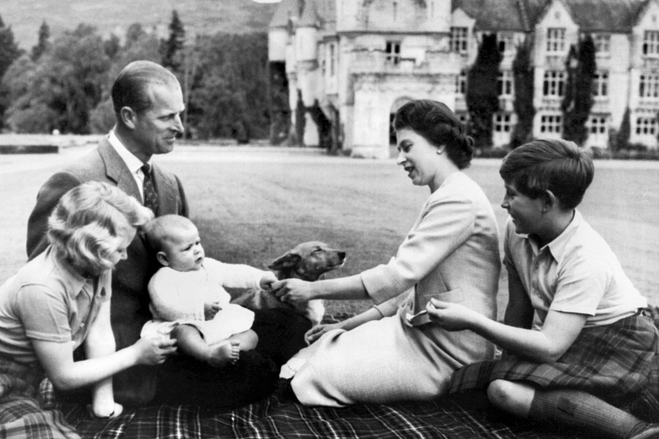 Queen Elizabeth II (second from r.), Prince Philip (second from l.), and their three children, Prince Charles (r.), Princess Anne (l.), and Prince Andrew, pose on the grounds of Balmoral Castle on September 9, 1960.