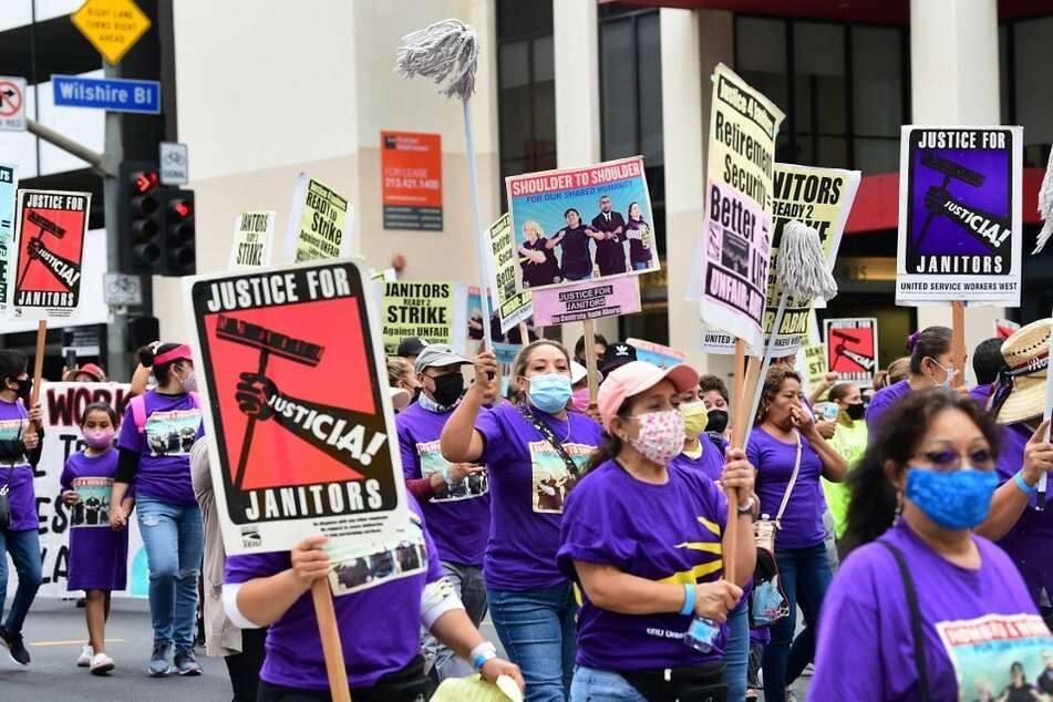 More than 1,000 janitors with the Service Employees International Union rally and march in Los Angeles.