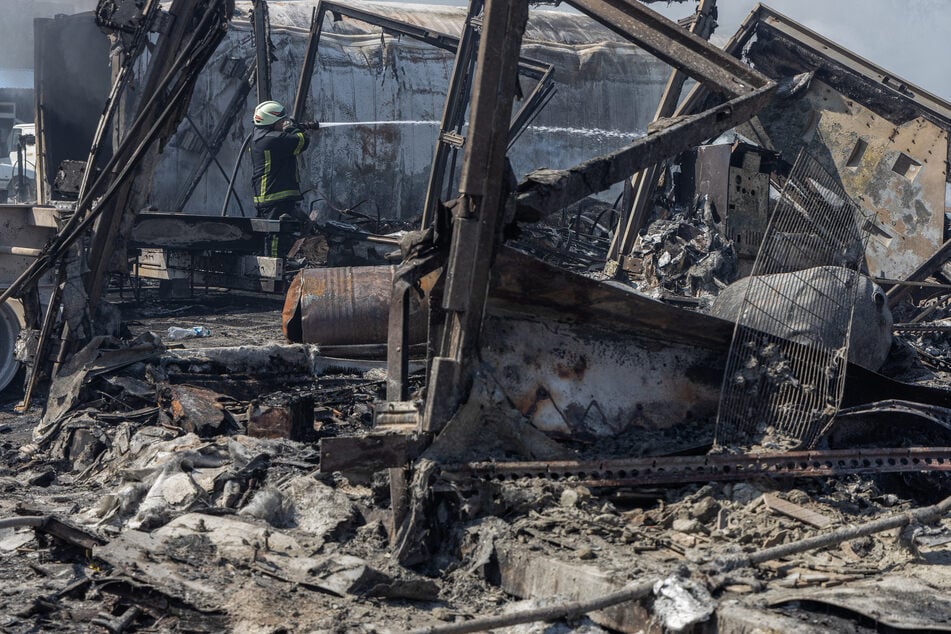 A Ukrainian firefighter extinguishes a fire on a site following an air attack, in the Odesa region, on Monday, amid the Russian invasion of Ukraine. Russian drones and missiles on Monday targeted 15 regions across Ukraine in an overnight barrage aimed mainly at energy infrastructure, Ukrainian Prime Minister Denys Shmygal said.