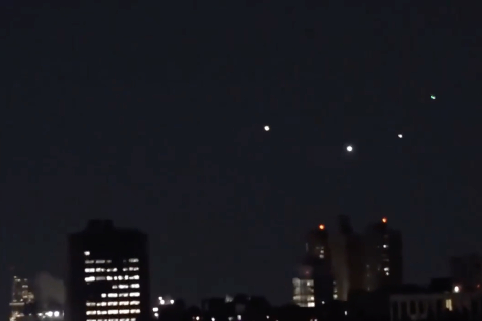 Video footage shared on social media captures what many believe to be drones above New York.