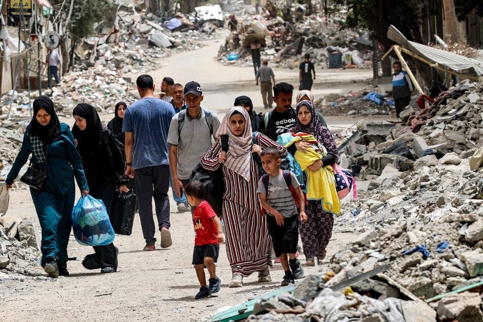 Displaced Palestinians evacuate from the Tal al-Zaatar camp for refugees in the northern Gaza Strip.