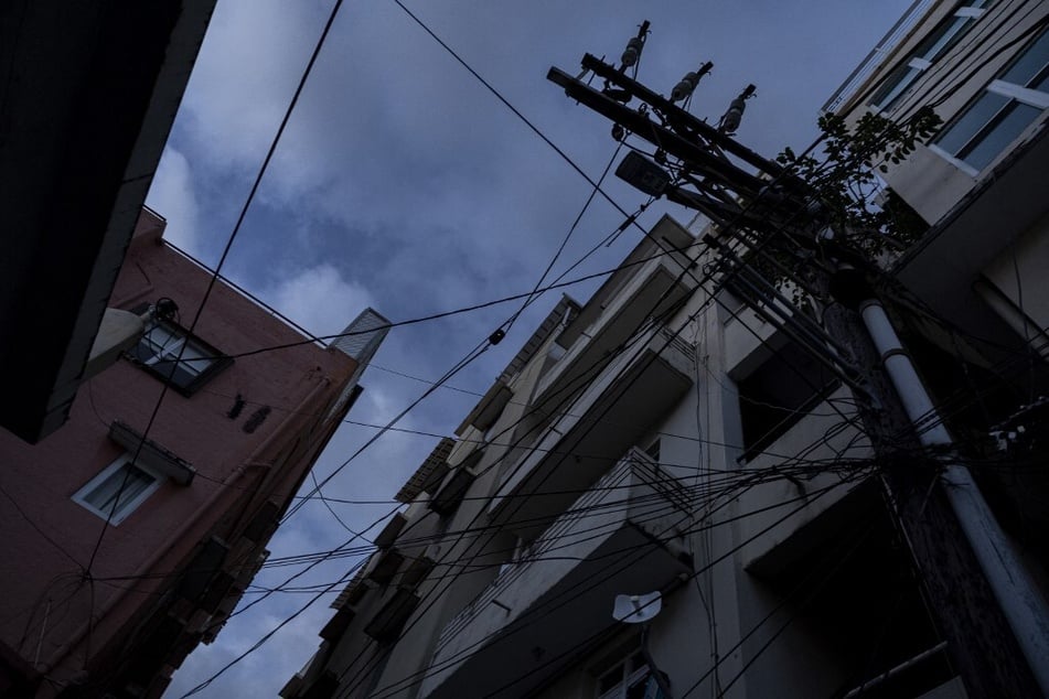 Power and communication lines are seen on a dark street in San Juan, Puerto Rico, after a major power outage hit the island on December 31, 2024.