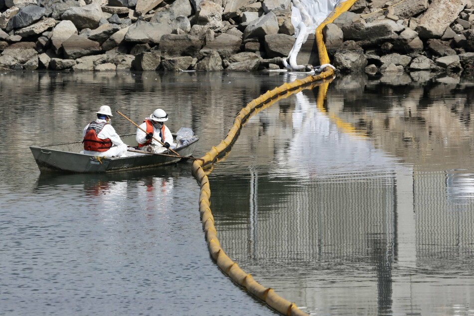 Workers collected oil and pollution from the water at Huntington Beach in Orange County, California.