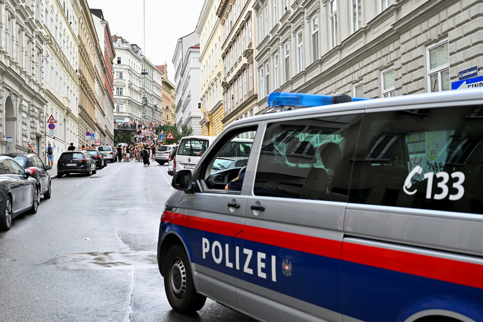 A police vehicle patrols as Swifties gather following the cancellation of three Taylor Swift concerts in Vienna, Austria.