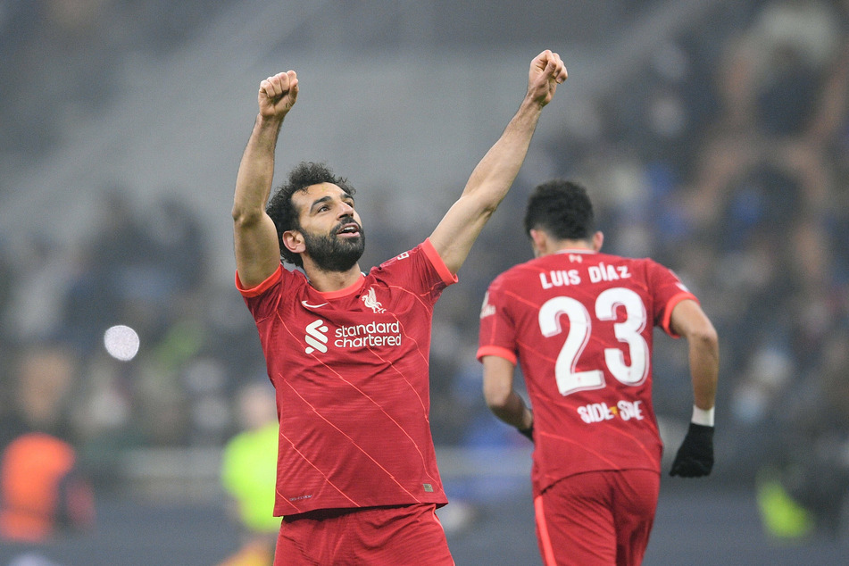 Salah salutes the Liverpool fans up high in the San Siro.