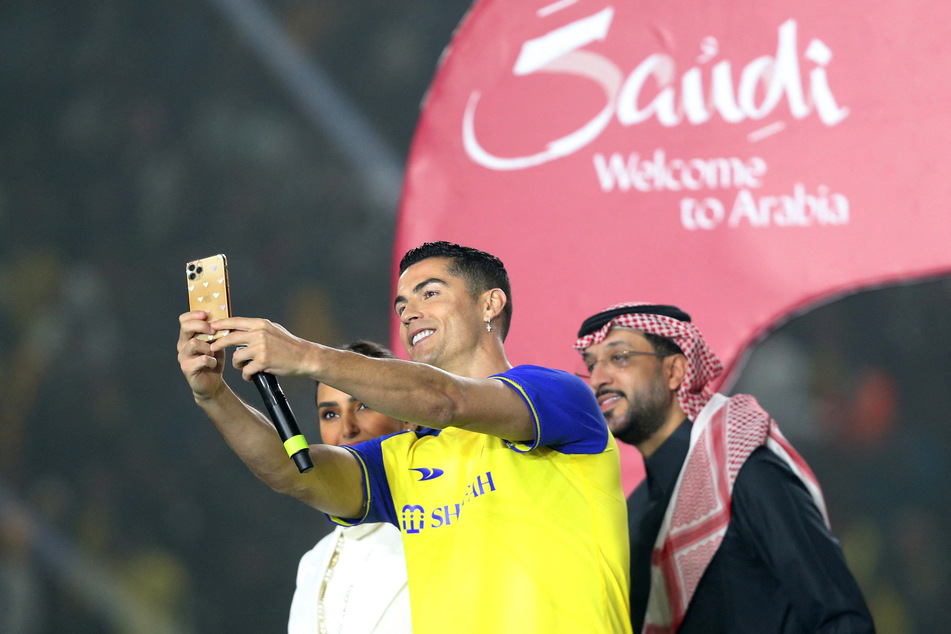 Cristiano Ronaldo takes a selfie during his presentation at Mrsool Park in Riyadh.