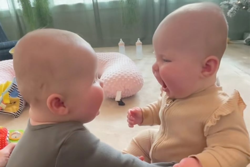 Die zweieiigen Zwillinge amüsieren sich köstlich, als sie sich auf diese Weise zum ersten Mal sehen.