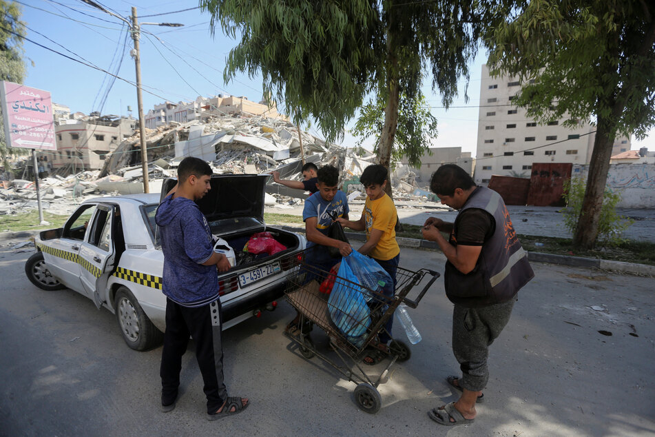 Palestinians pack up amid Israeli orders for hundreds of thousands of people to evacuate Gaza City.