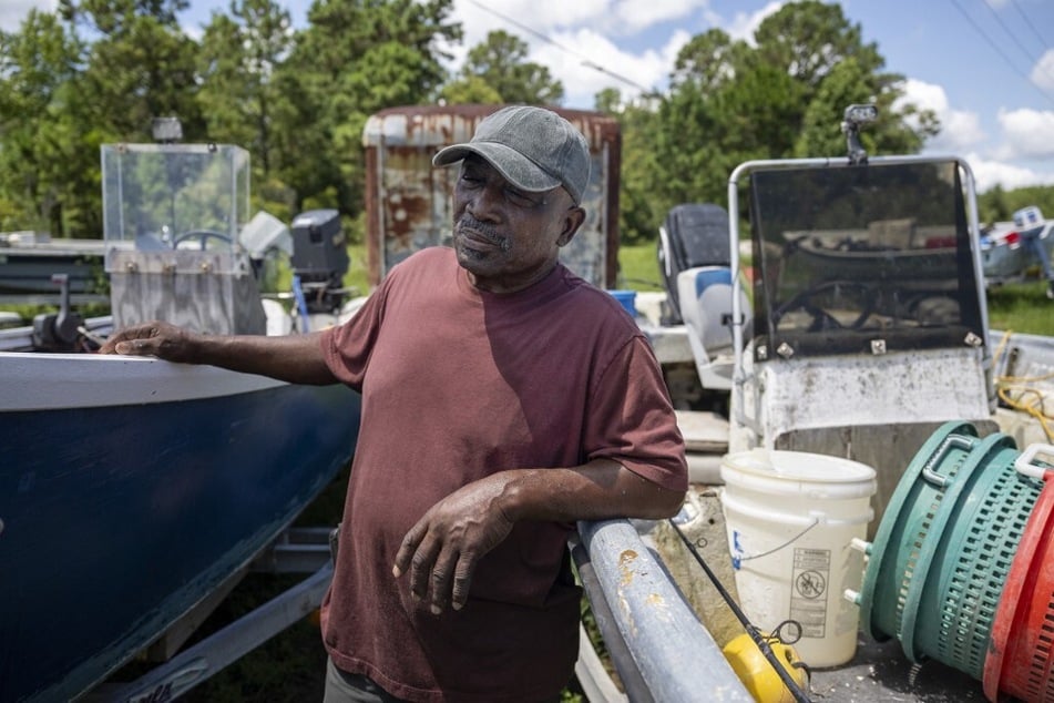Ed Atkins, Gullah Geechee fisherman and owner of Atkins Live Bait, stands near his fishing boats in Saint Helena, South Carolina.