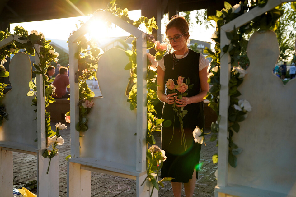 People pay tribute to those killed in the Highland Park shooting.