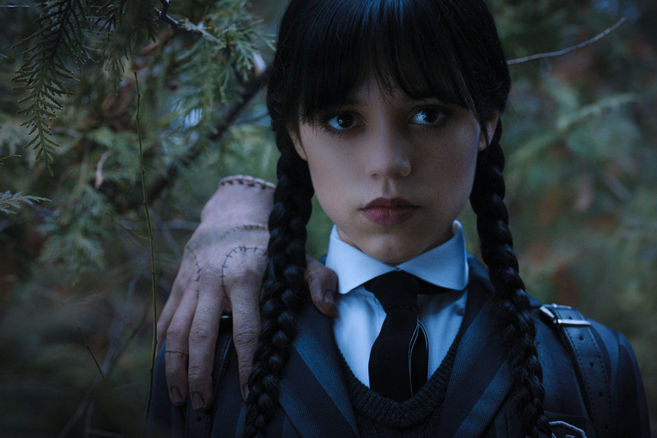 Thing and Wednesday Addams, played by Jenna Ortega, in season 1 of Netflix's most popular current series, Wednesday.