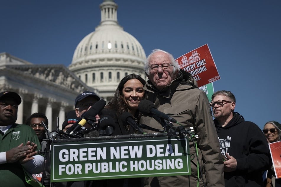 Senator Bernie Sanders (r.) and Representative Alexandria Ocasio-Cortez speak at a press conference outside the Capitol on the reintroduction of the Green New Deal for Public Housing Act.