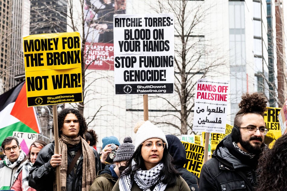 New Yorkers raise signs reading "Money for the Bronx, Not War!" and "Ritchie Torres: Blood on Your Hands, Stop Funding Genocide!" during a demonstration in support of Palestine.