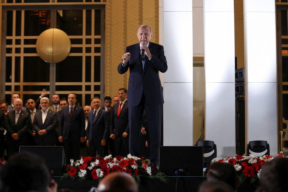 Turkish President Tayyip Erdogan addresses his supporters following his victory in the second round of the presidential election at the Presidential Palace in Ankara, Turkey.