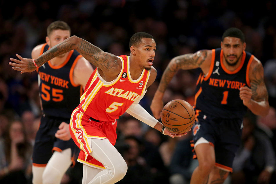 Atlanta Hawks guard Dejounte Murray brings the ball up court against New York Knicks center Isaiah Hartenstein and forward Obi Toppin during the second quarter at Madison Square Garden.