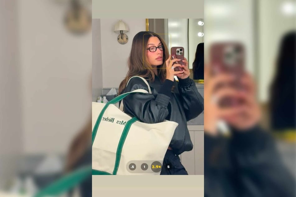 In the post, Hailey Bieber snaps a selfie of herself wearing a green and white LL Bean tote bag with the words "Mrs. Bieber" embroidered prominently.