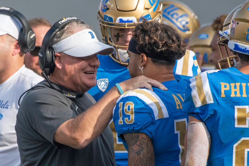 UCLA football head coach Chip Kelly talks to one of his players during a game against the USC Trojans on November 20.