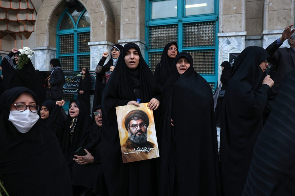 Iranians hold pictures of Hezbollah leader Hassan Nasrallah, who was killed in an Israeli air strike on Beirut's southern suburbs on September 27, during an anti-Israel protest in Palestine Square in Tehran on September 30, 2024.