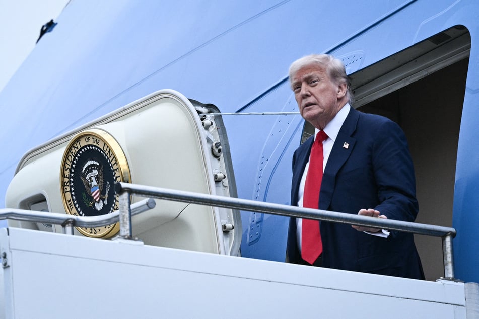 President Donald Trump disembarks from Air Force One upon his arrival at Prestwick Airport, south of Glasgow, on the first day of his UK visit.
