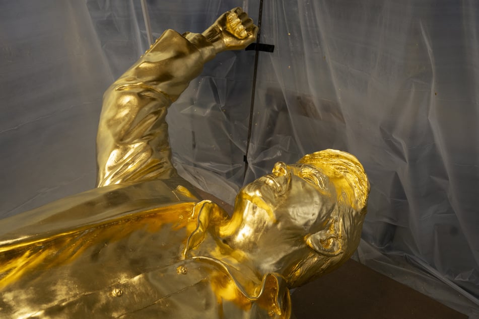 The bust portion of a 15-foot bronze statue of President Donald Trump, coated in gold leaf, lies on its back in the studio of sculptor Alan Cottrill in Zanesville, Ohio, on February 5, 2026.