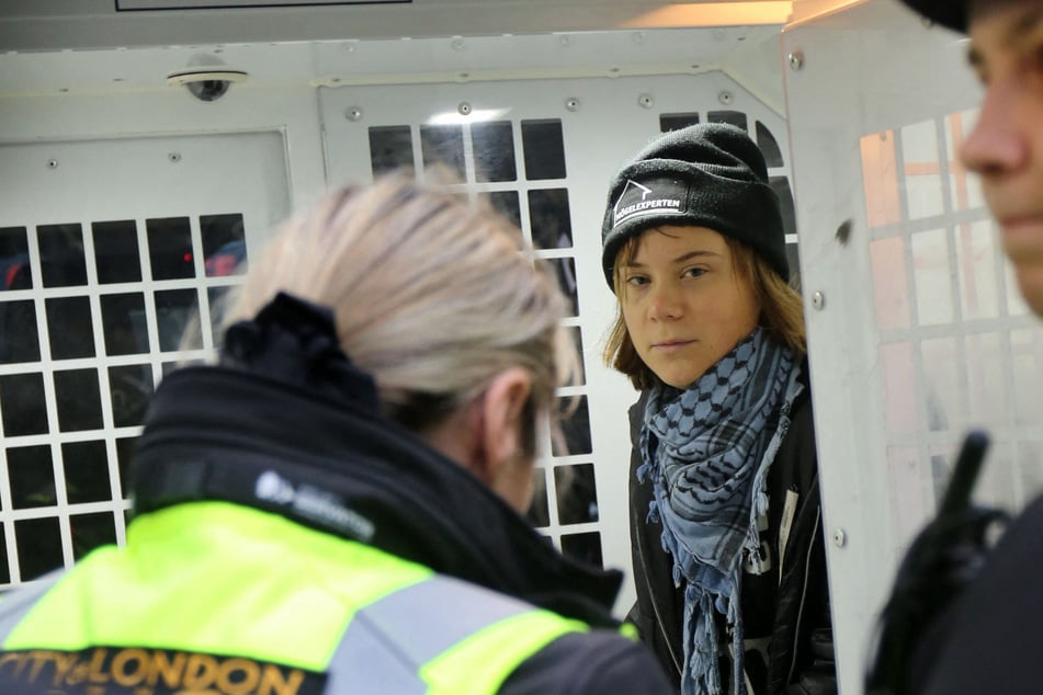 Greta Thunberg held a sign that read, "I support Palestine Action prisoners. I oppose genocide."