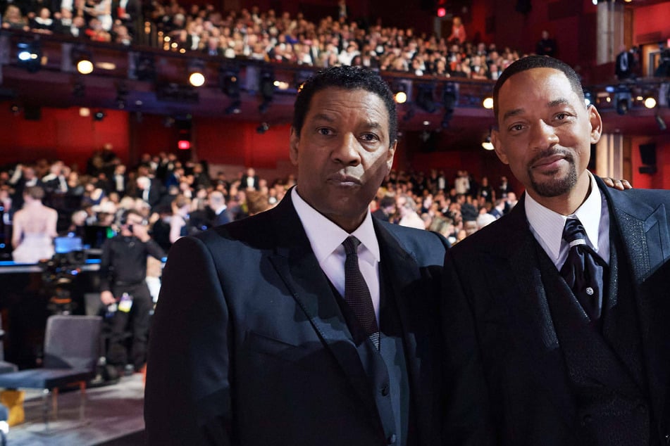 Over the weekend, Denzel Washington (l) addressed Will Smith (r) and Chris Smith's Oscars incident and why he got up to comfort Will afterwards.