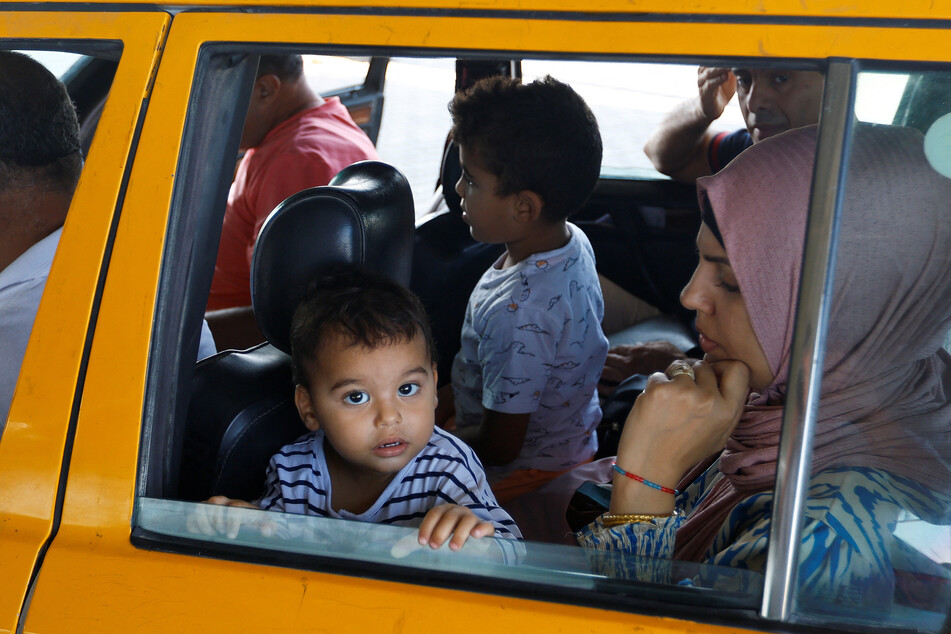 A child looks out from a car as Palestinians, including foreign passport holders, wait at Rafah border crossing in the southern Gaza Strip.