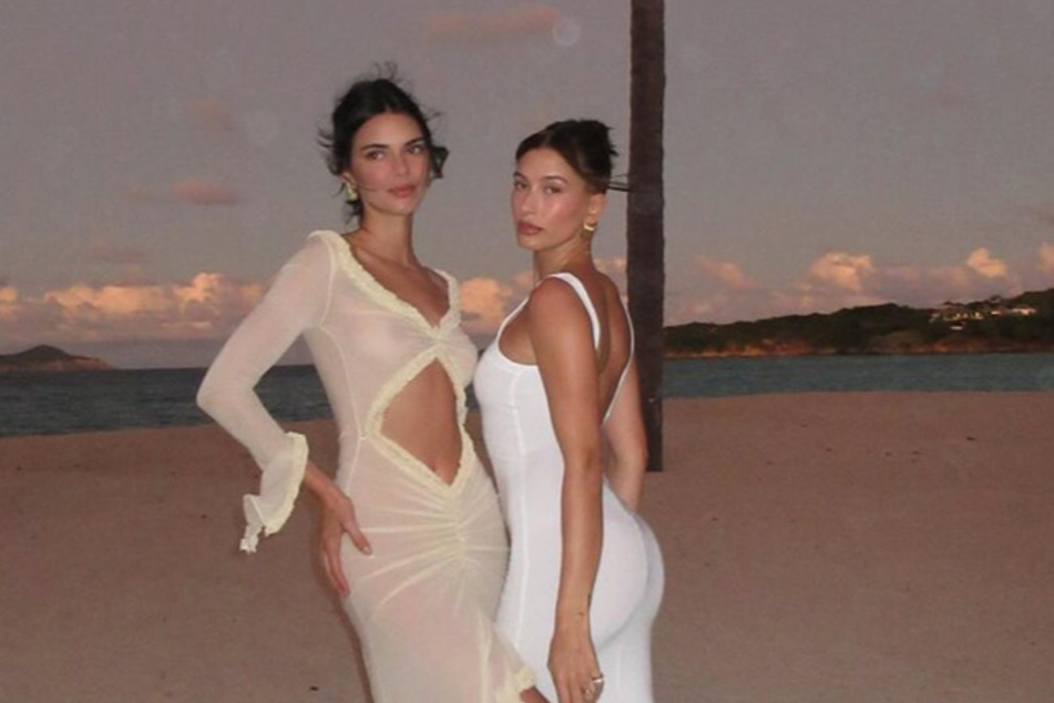 Kendall Jenner poses with her BFF, Hailey Bieber (r), on a beach in Barbados.