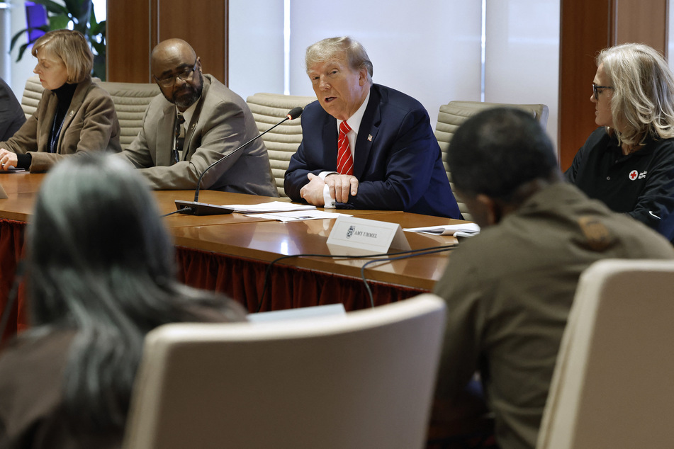 Republican presidential candidate and former US President Donald Trump (C) meets with International Brotherhood of Teamsters leaders and members, including Trustee Willie Ford (2nd L), Vice President At-Large Joan Corey (1st L), and other leaders and members at their headquarters on Wednesday in Washington, DC.