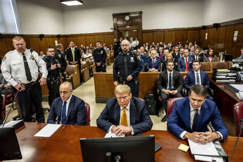 Donald Trump (c.) sitting in the courtroom at Manhattan Criminal Court in New York for his hush money trial on Tuesday, May 21, 2024.