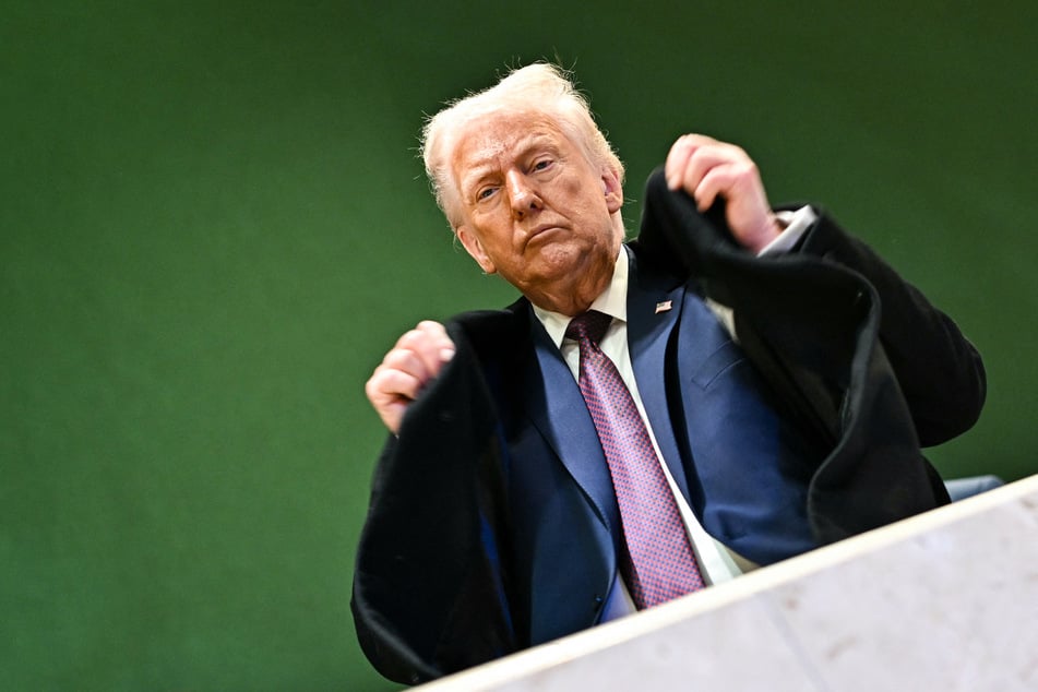 President Donald Trump adjusts his jacket during the World Economic Forum annual meeting in Davos, Switzerland, on January 22, 2026.