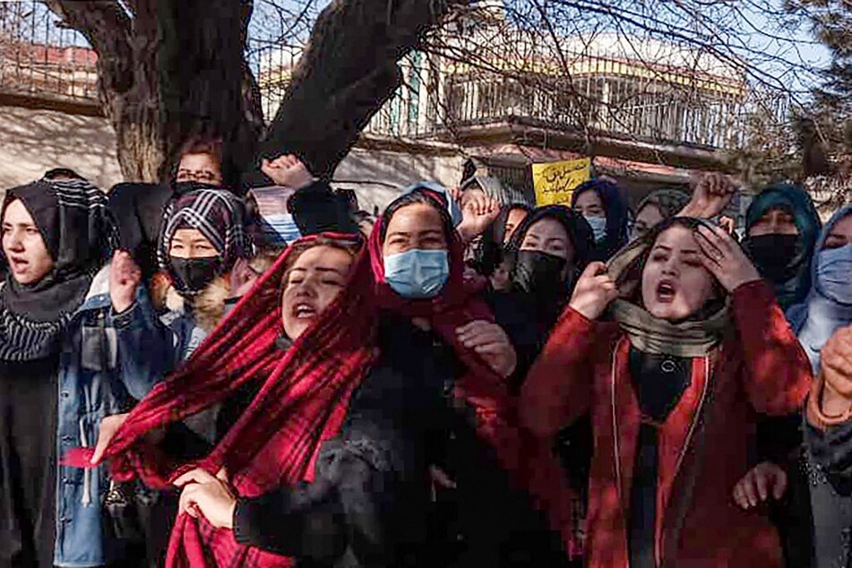 Afghan women chant slogans to protest against the ban on university education for women, in Kabul on December 22, 2022.
