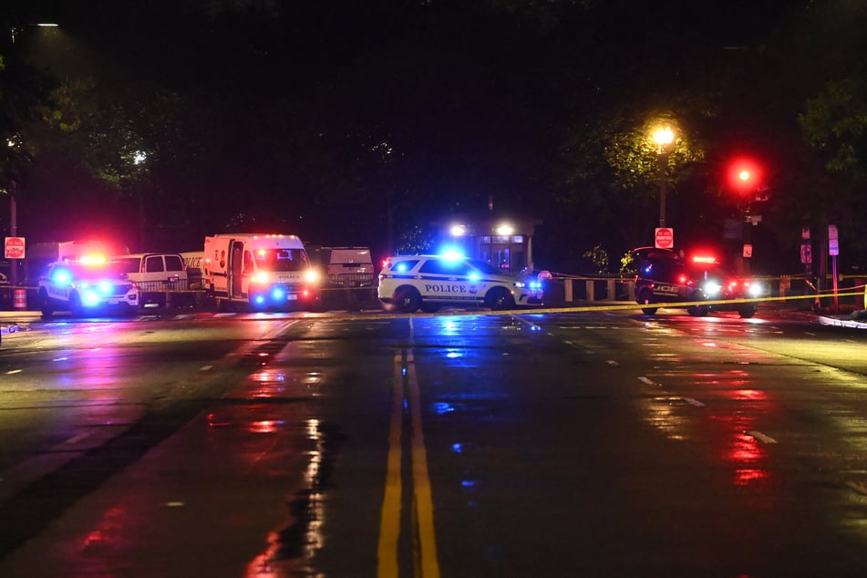Police vehicles and tape blocks off a crime scene near the White House after a gunman opened fire in Washington, DC, on Saturday.