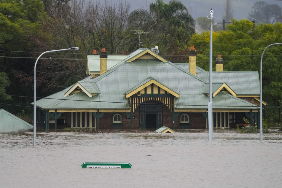 Ein Gebäude auf einer Seite der Windsor-Brücke in Windsor am Stadtrand von Sydney steht unter Wasser.