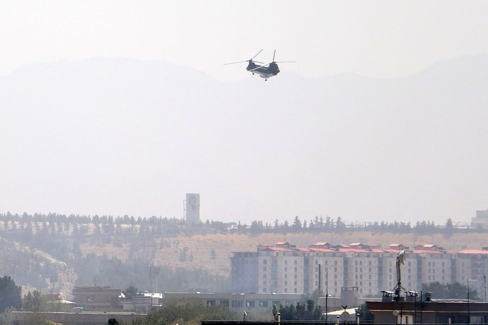 A Sea Knight military transport helicopter flies over Kabul as the Taliban enter Kabul, Afghanistan, on Sunday.