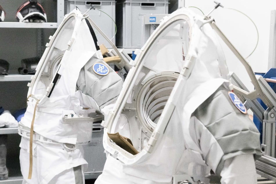 In der weltweit einzigartigen Mondtrainingsanlage beim DLR in Köln können Astronauten den Einsatz im Weltall trainieren und dafür unter anderem in Übungsraumanzüge schlüpfen.