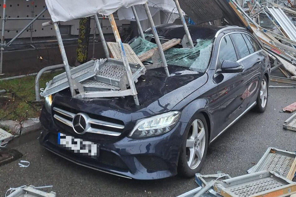 Ein rund 15 Meter hohes Gerüst ist durch den Sturm Zoltan umgerissen worden und bohrte sich unter anderem durch diesen Mercedes.