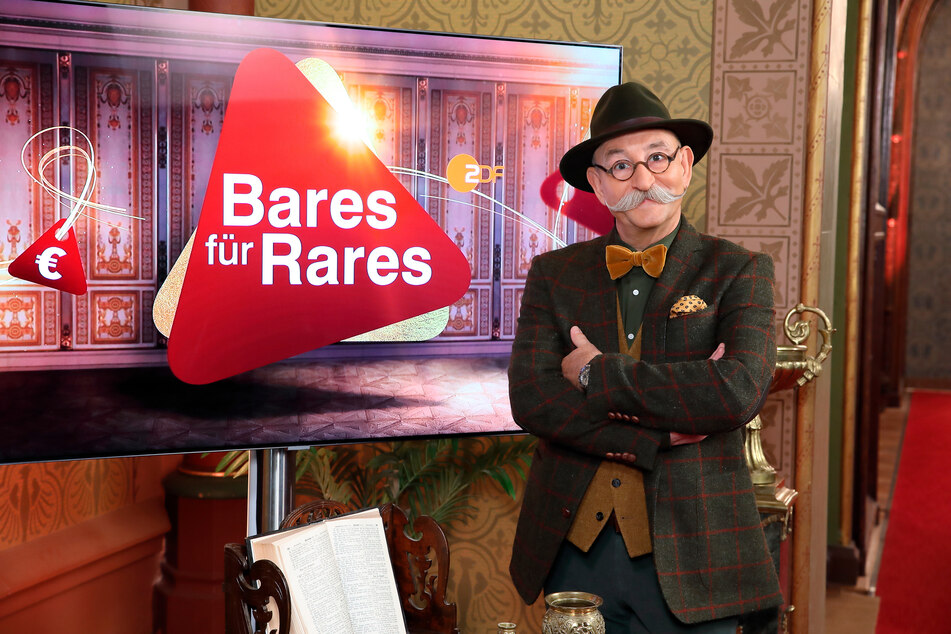 Moderator Horst Lichter steht neben dem Logo der Sendung "Bares für Rares". Die Trödelshow holte den klaren TV-Quotensieg.