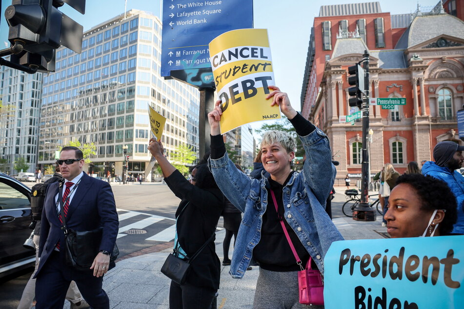 Activists call on President Biden to cancel student loan debt at a rally in Washington DC.
